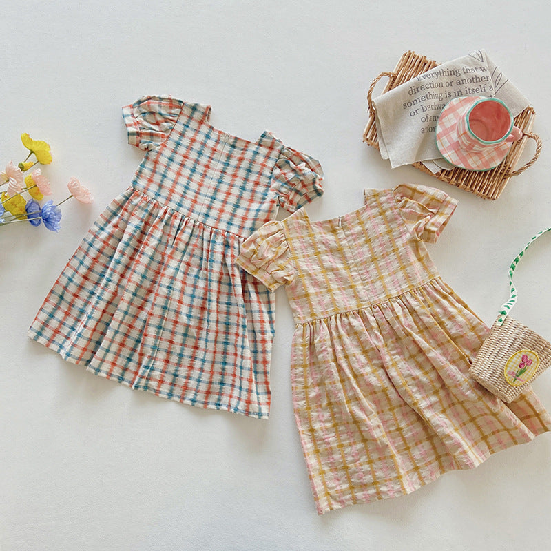 A colorful plaid dress for girls featuring short sleeves and heart embroidery, perfect for summer outings.