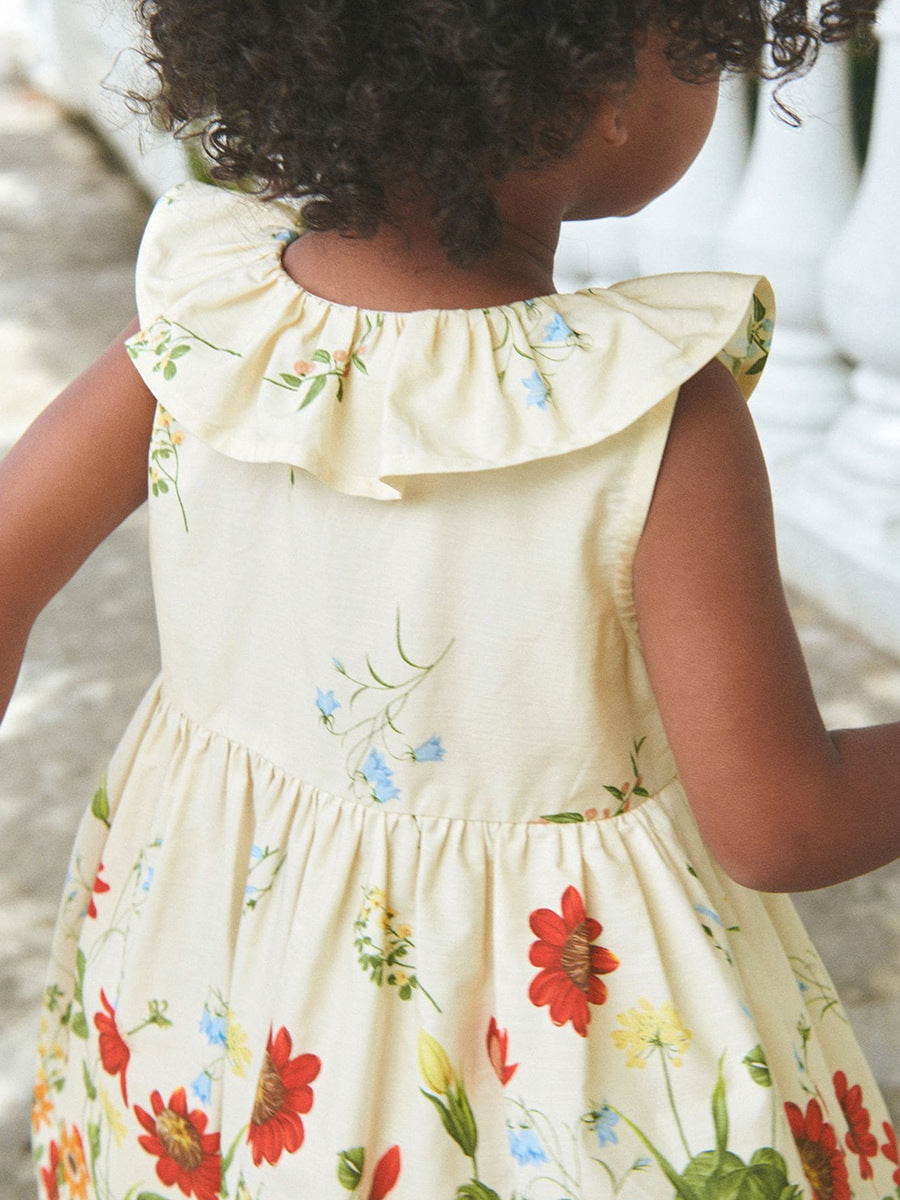 A beige sleeveless dress with a floral pattern, perfect for summer wear for girls.