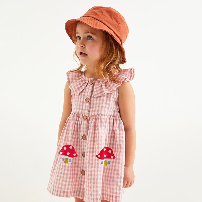 A pink sleeveless dress for girls featuring a plaid and cartoon mushroom house pattern, perfect for summer wear.