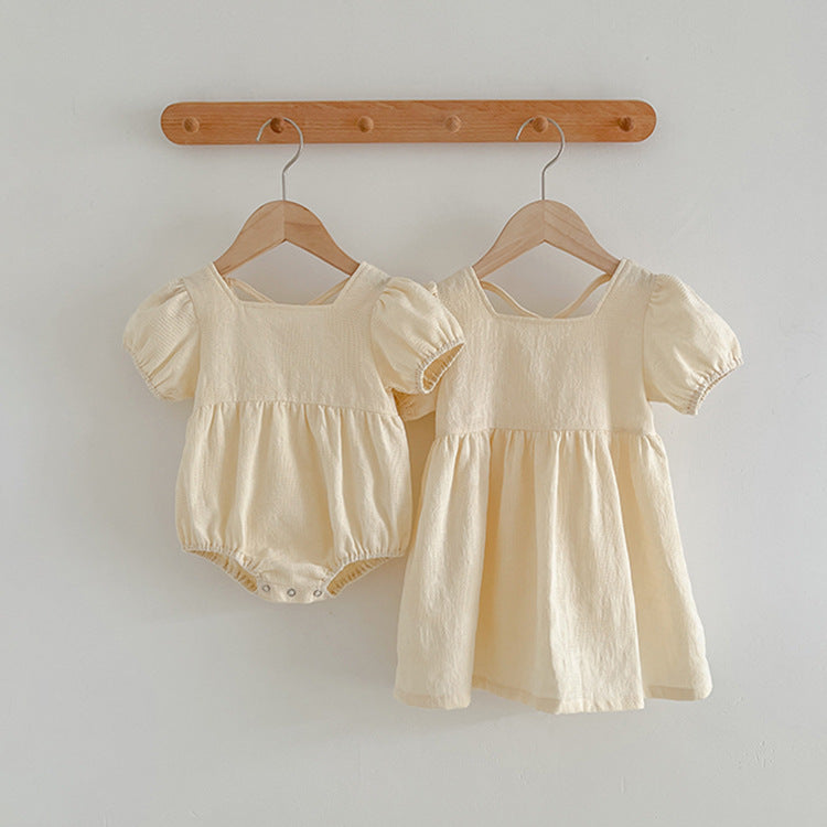 A stylish summer onesie for girls in beige and apricot colors, featuring a simple square neck design, made from soft cotton and polyester.