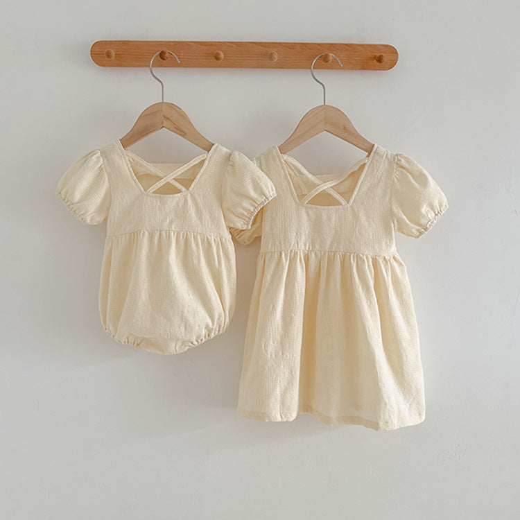 A stylish summer onesie for girls in beige and apricot colors, featuring a simple square neck design, made from soft cotton and polyester.