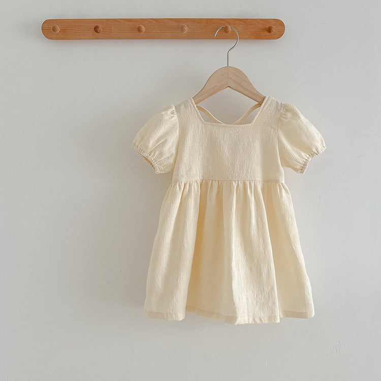 A stylish summer onesie for girls in beige and apricot colors, featuring a simple square neck design, made from soft cotton and polyester.