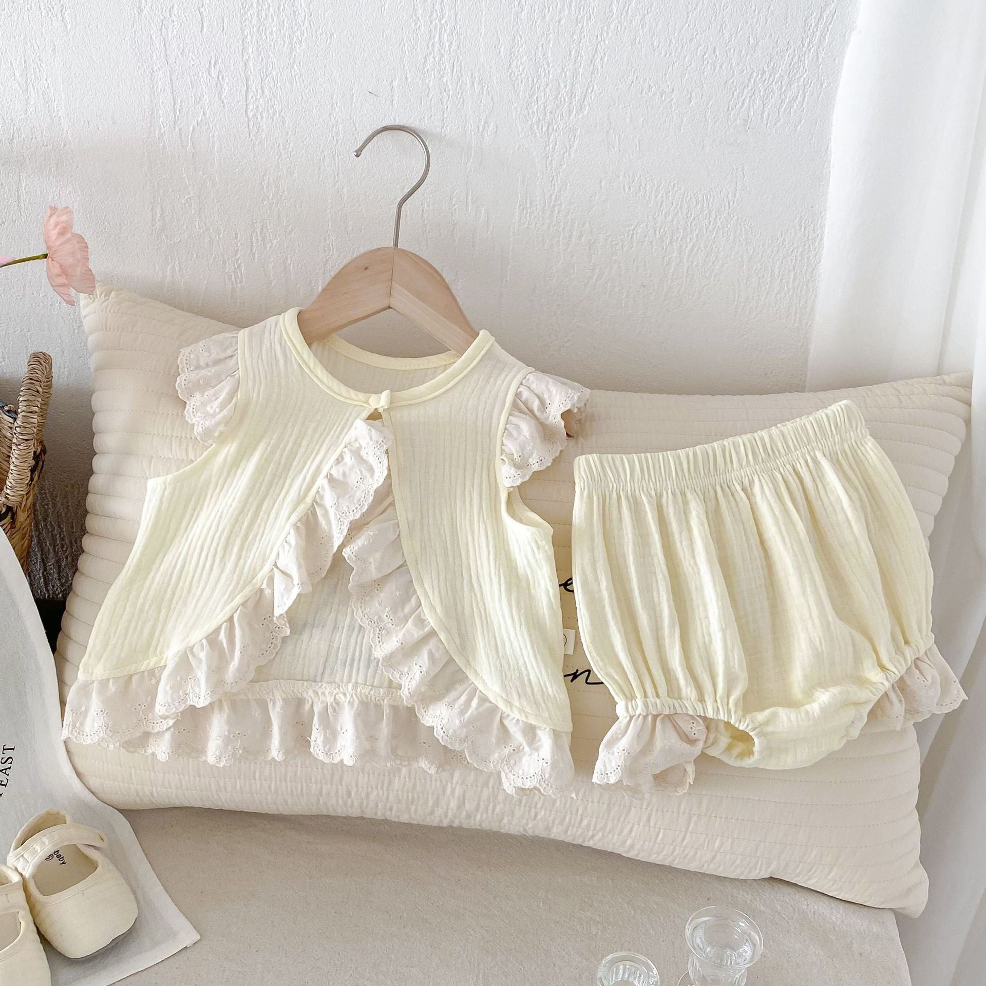 A stylish apricot dress for baby girls featuring fly sleeves and hollow out lace trim, perfect for summer wear.