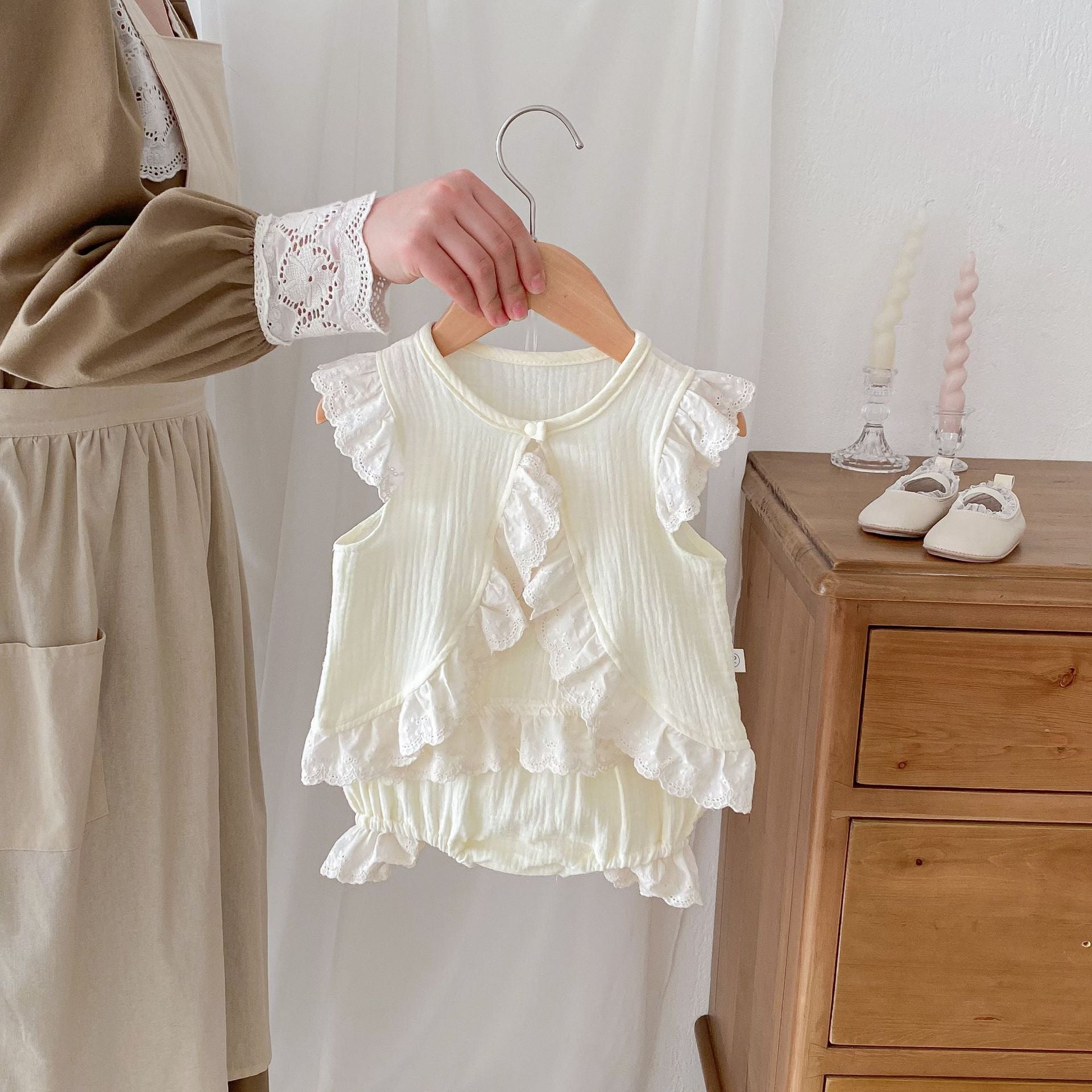 A stylish apricot dress for baby girls featuring fly sleeves and hollow out lace trim, perfect for summer wear.