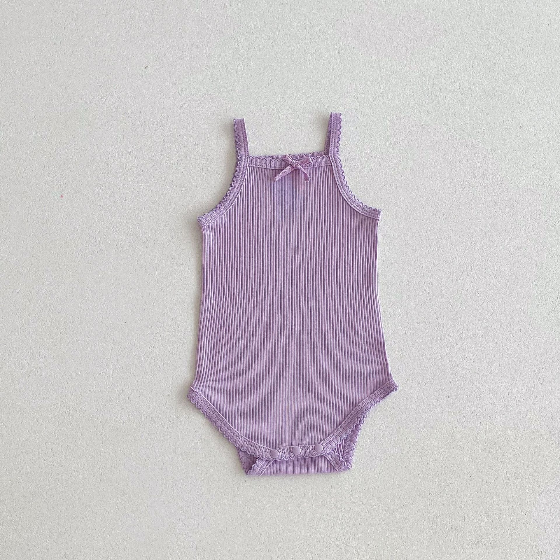 A collection of soft cotton baby girls onesies in solid colors: pink, purple, green, grey, and beige, perfect for summer wear.