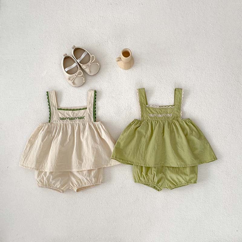 A stylish baby girl's sleeveless dress with lace trim, available in green and beige, perfect for summer wear.