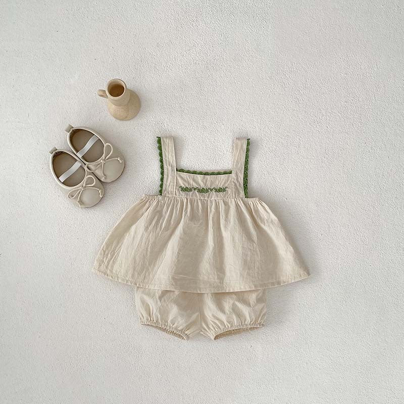 A stylish baby girl's sleeveless dress with lace trim, available in green and beige, perfect for summer wear.