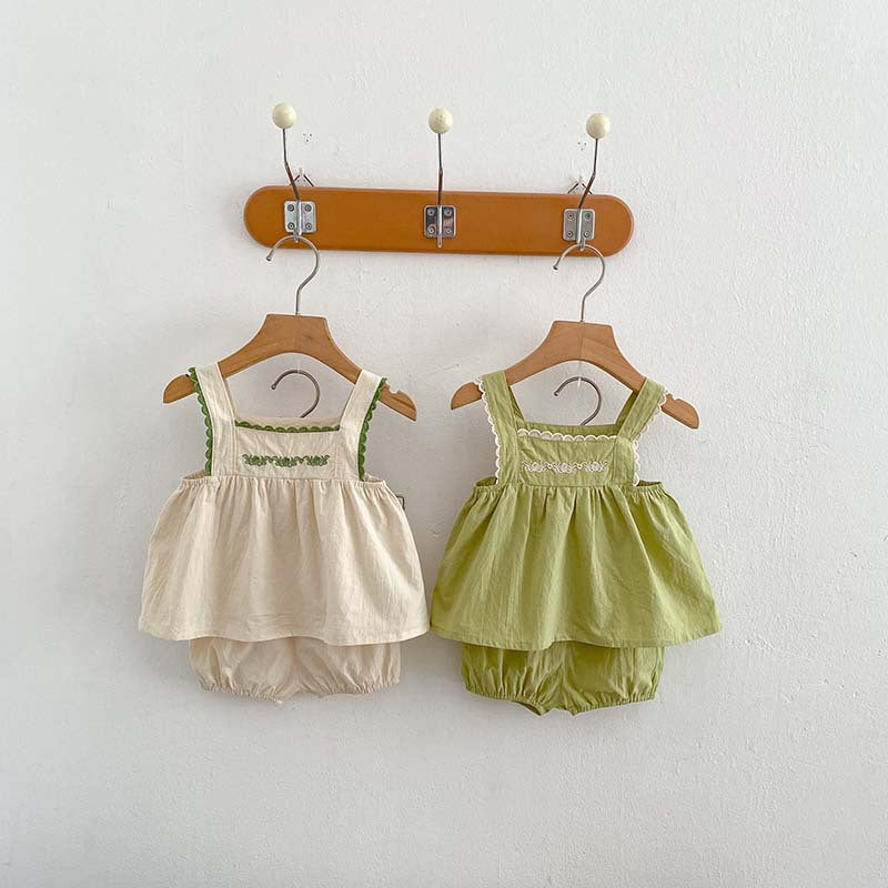 A stylish baby girl's sleeveless dress with lace trim, available in green and beige, perfect for summer wear.