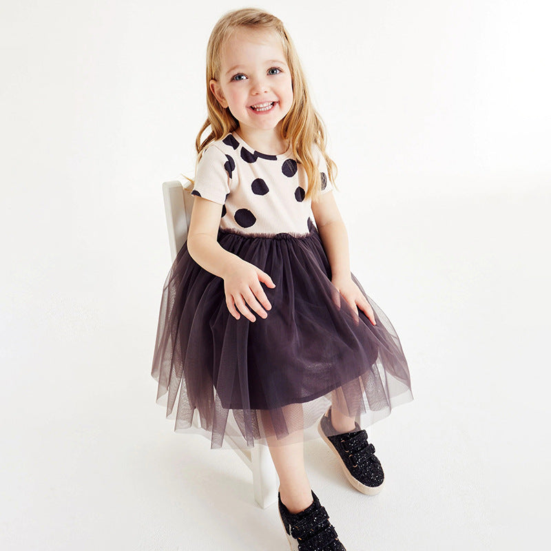 A stylish summer dress for girls featuring short sleeves, a polka dot pattern, and mesh patchwork, perfect for warm weather.