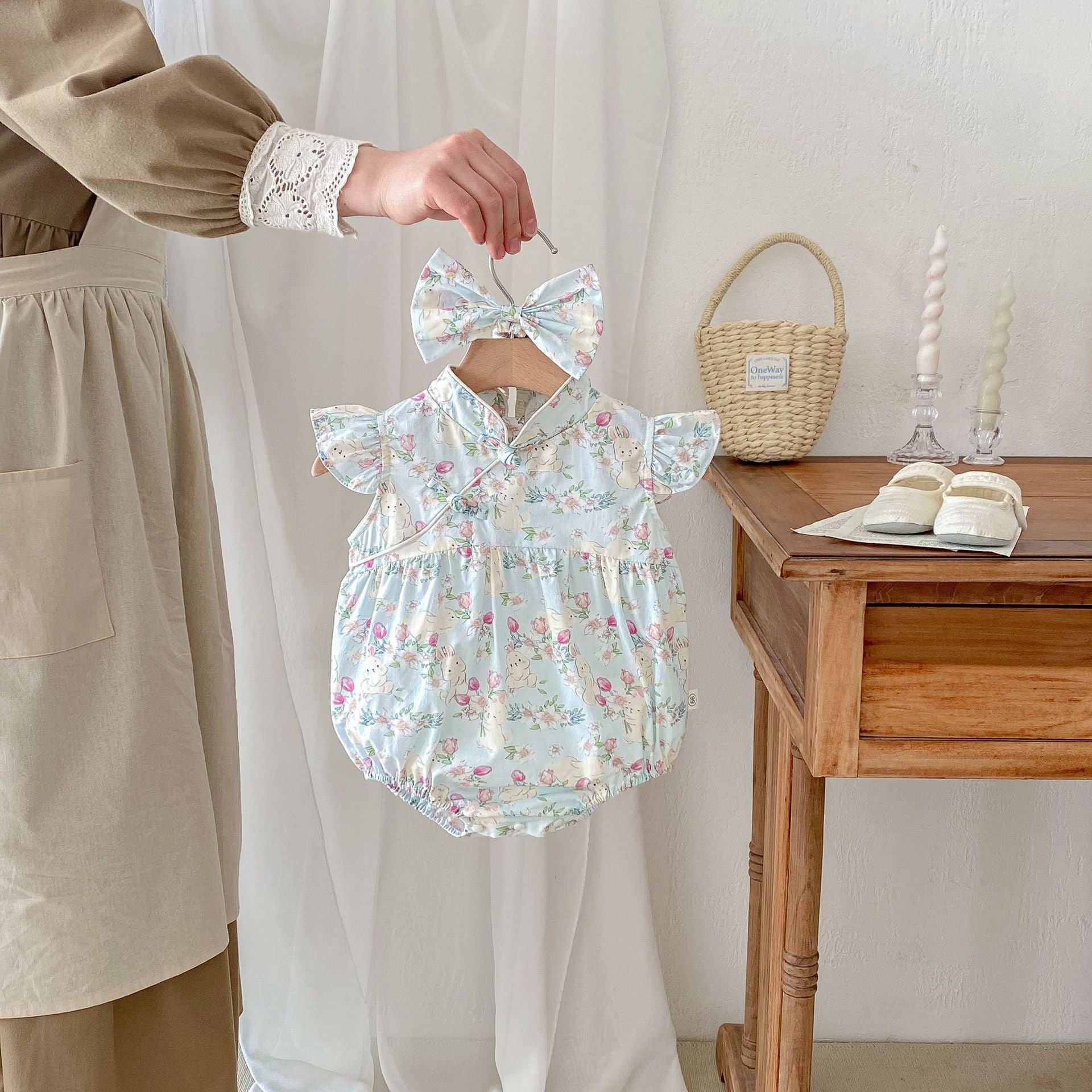 A cute blue summer dress for baby girls featuring cartoon animal patterns and fly sleeves, perfect for warm weather outings.