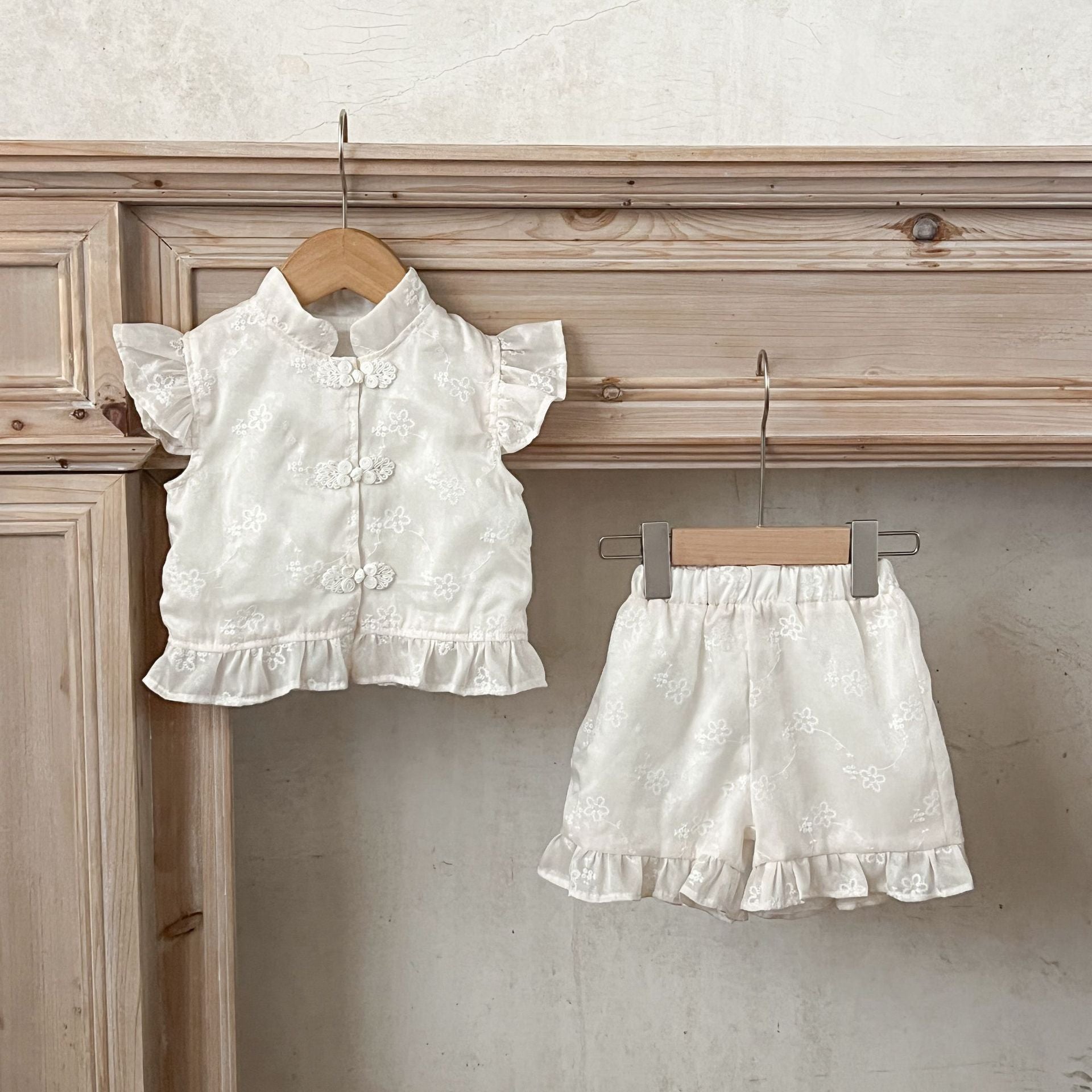 Summer dress for baby girls featuring fly sleeves and a stand collar in beige cotton with embroidered details.