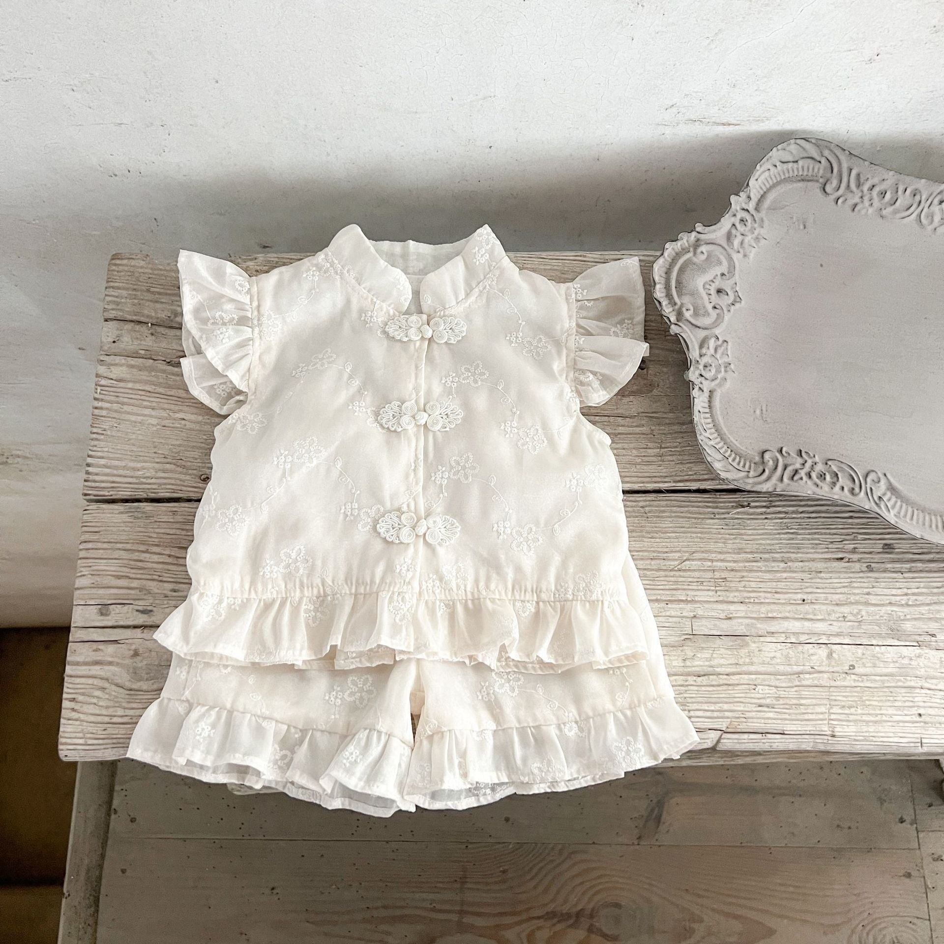 Summer dress for baby girls featuring fly sleeves and a stand collar in beige cotton with embroidered details.