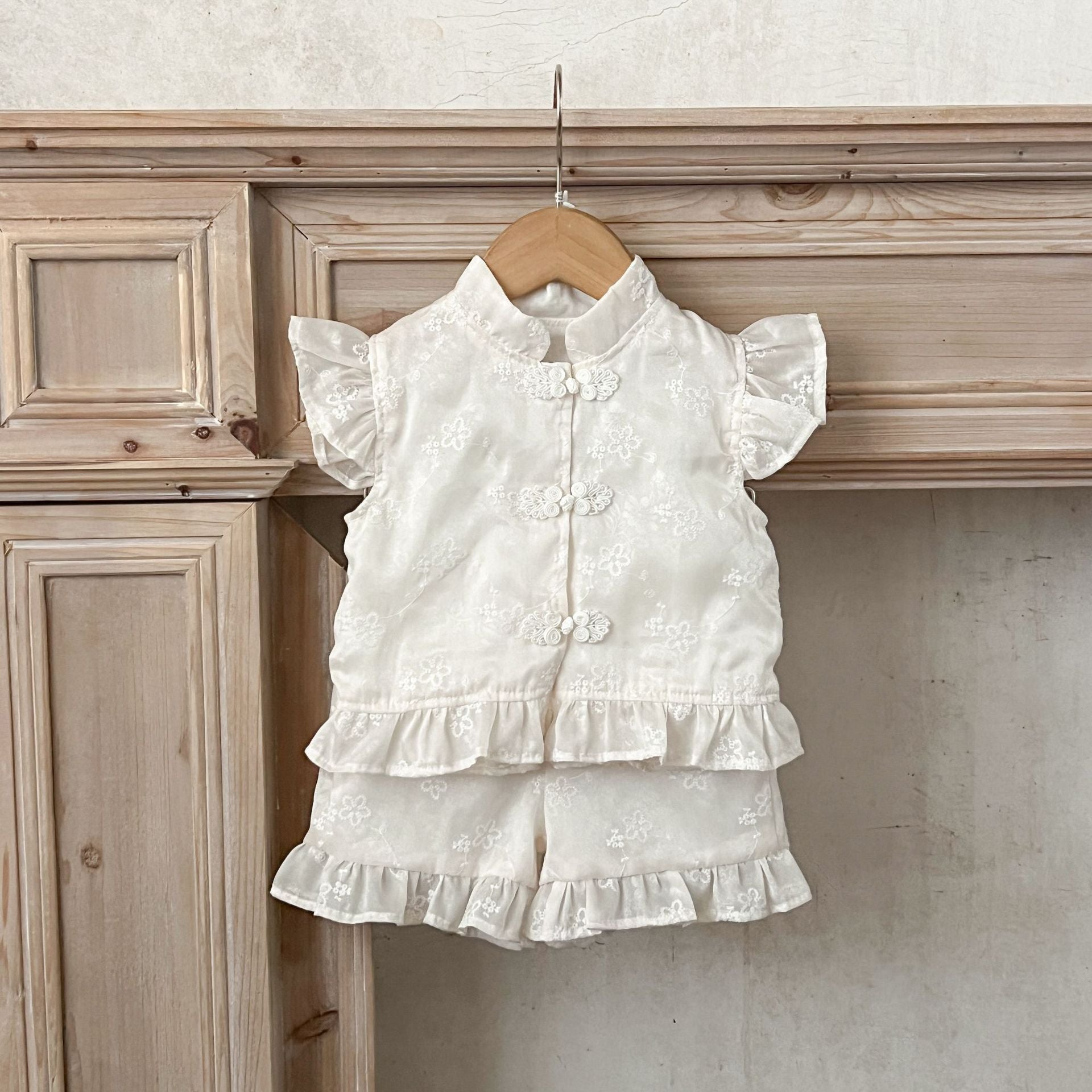 Summer dress for baby girls featuring fly sleeves and a stand collar in beige cotton with embroidered details.