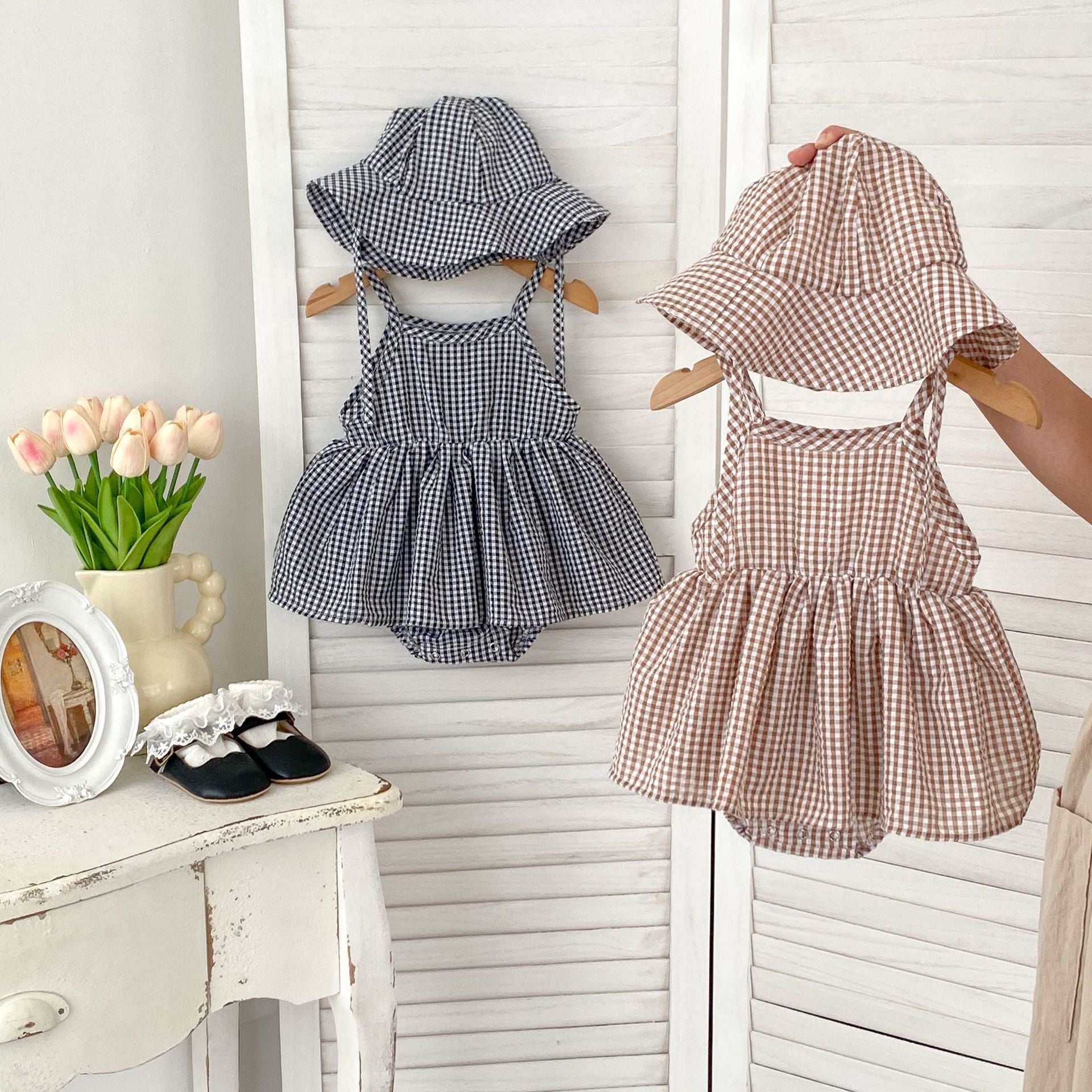 Summer New Arrival Baby Girls Plaid Sleeveless Strap Onesies Dress in black and brown colors, made from soft cotton, perfect for warm weather.