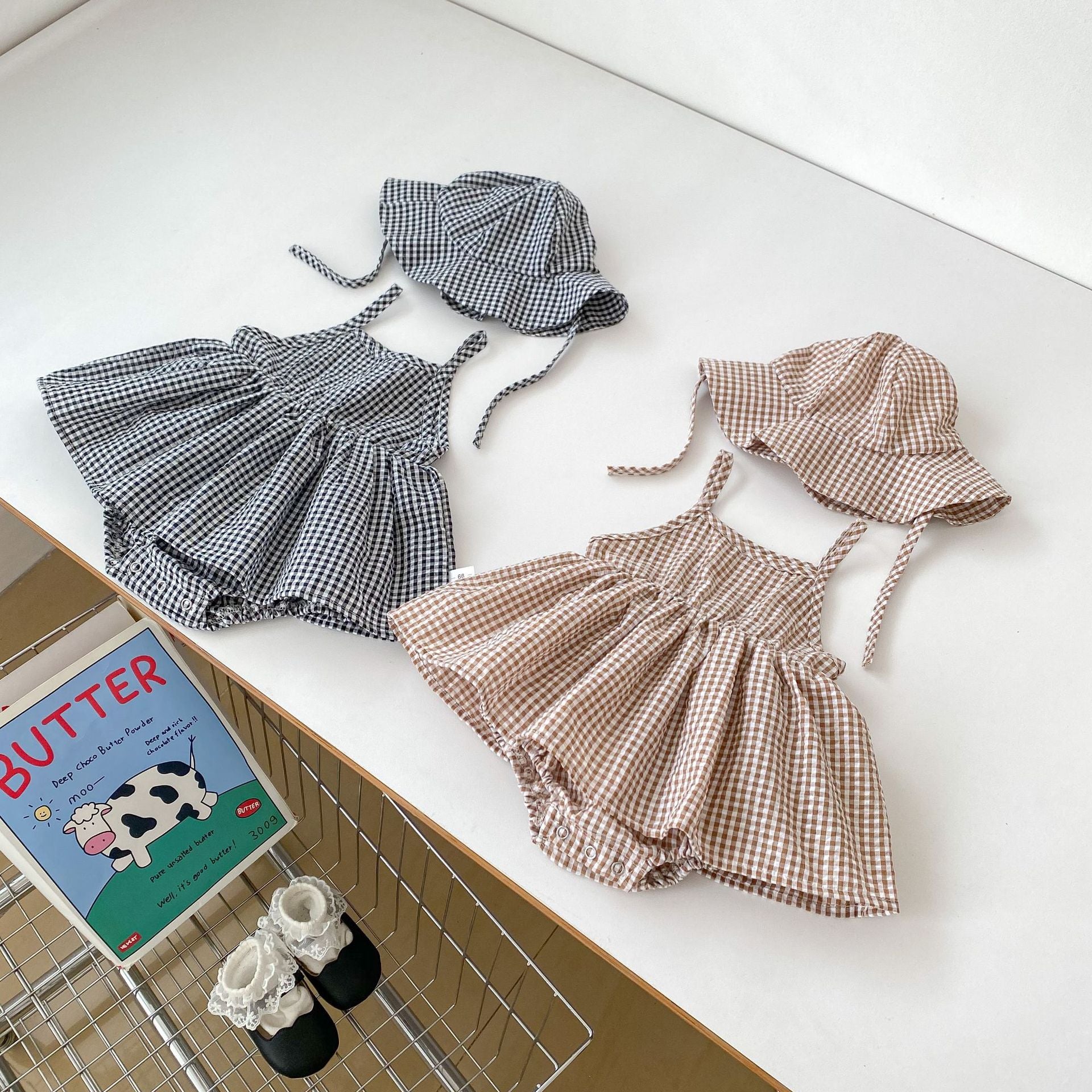 Summer New Arrival Baby Girls Plaid Sleeveless Strap Onesies Dress in black and brown colors, made from soft cotton, perfect for warm weather.