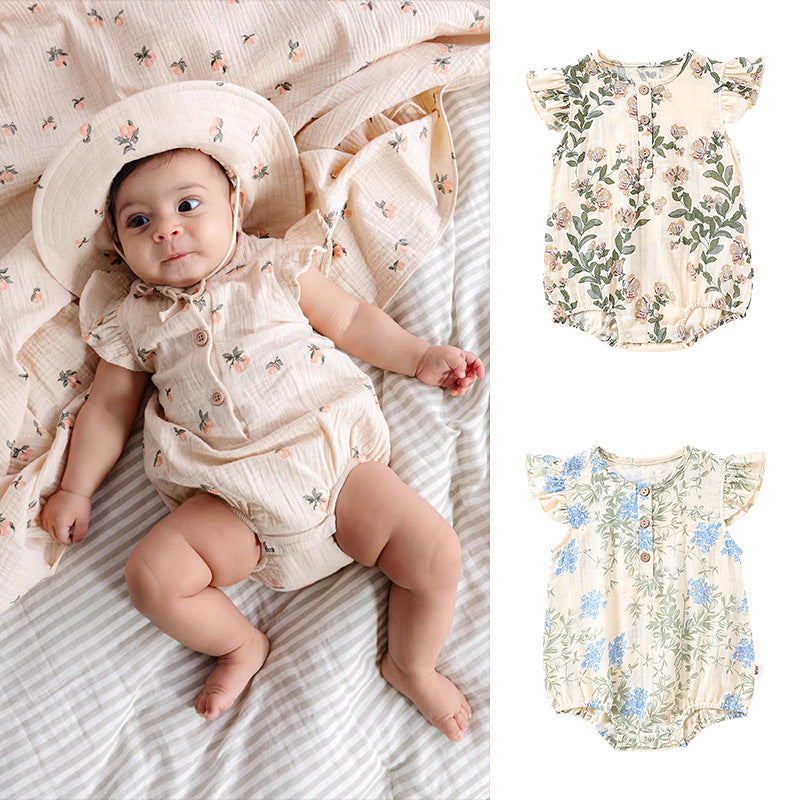 A cute baby girl wearing a floral print dress with fly sleeves in blue and gold, perfect for summer outings.