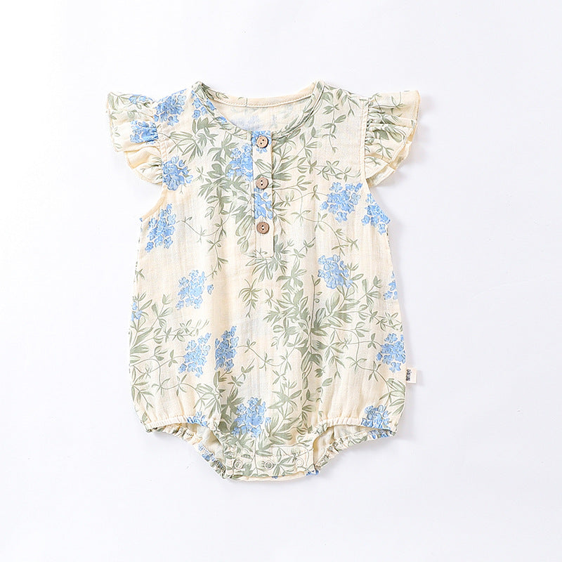 A cute baby girl wearing a floral print dress with fly sleeves in blue and gold, perfect for summer outings.