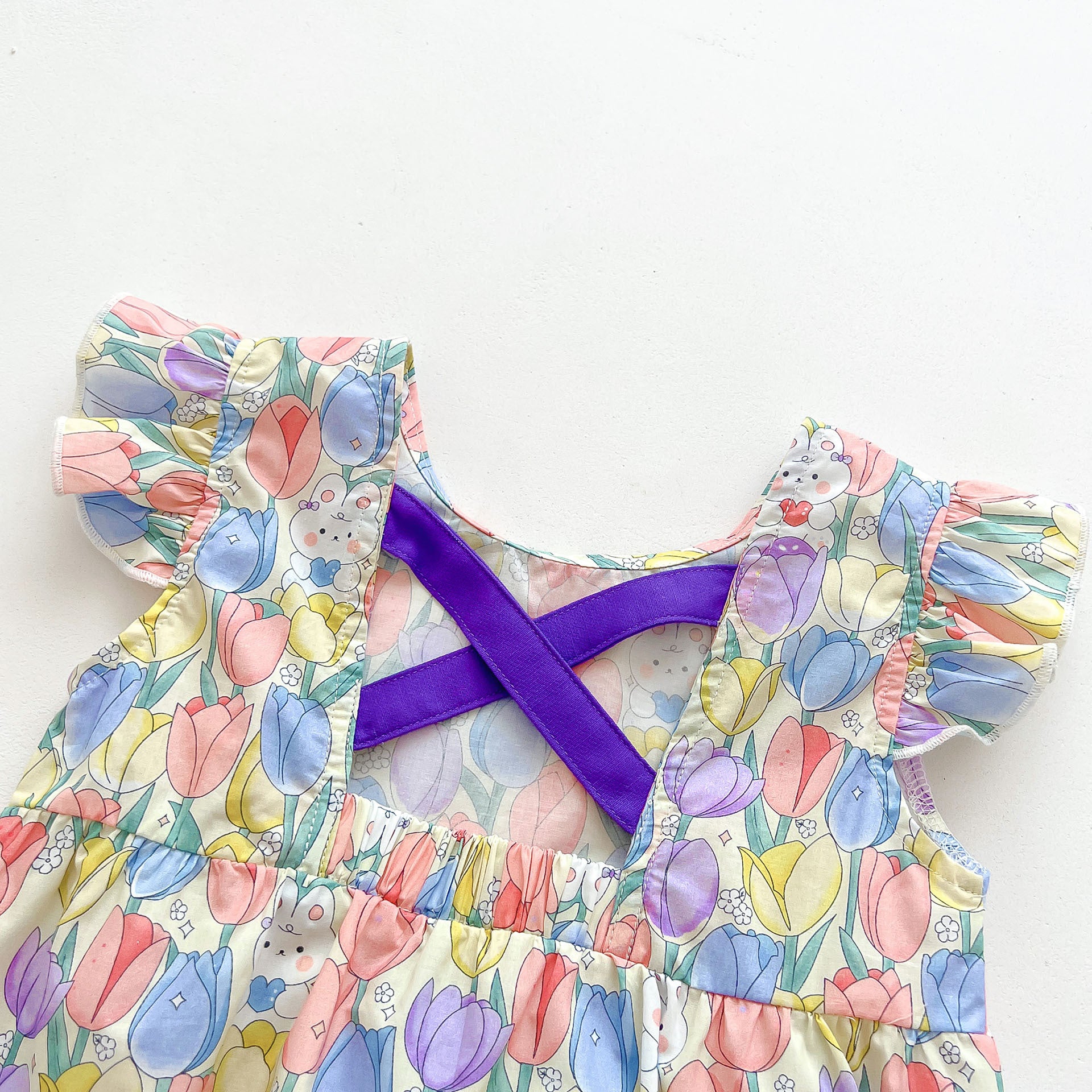 A cute purple dress for baby girls featuring a rabbits and flowers print with fly sleeves, perfect for summer outings.