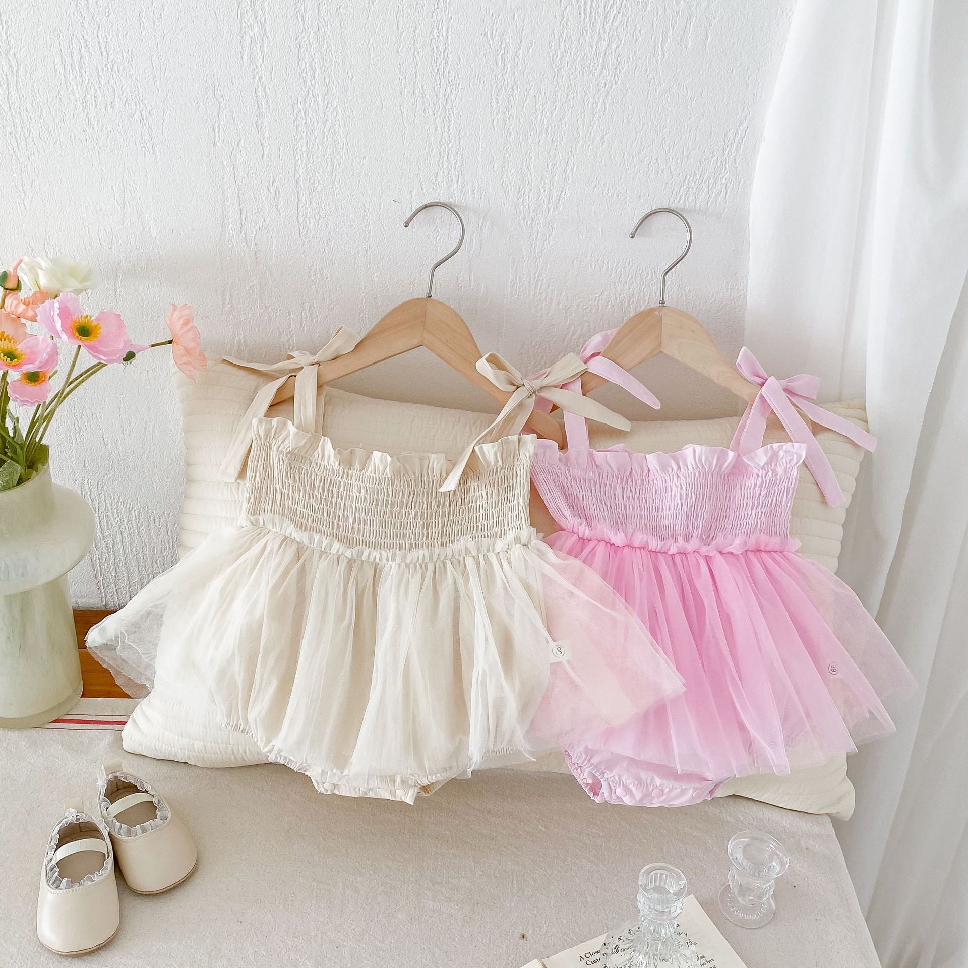 Summer New Arrival Baby Girls Sleeveless Solid Color Pleated Strap dress in pink and beige, made from cotton and polyester.