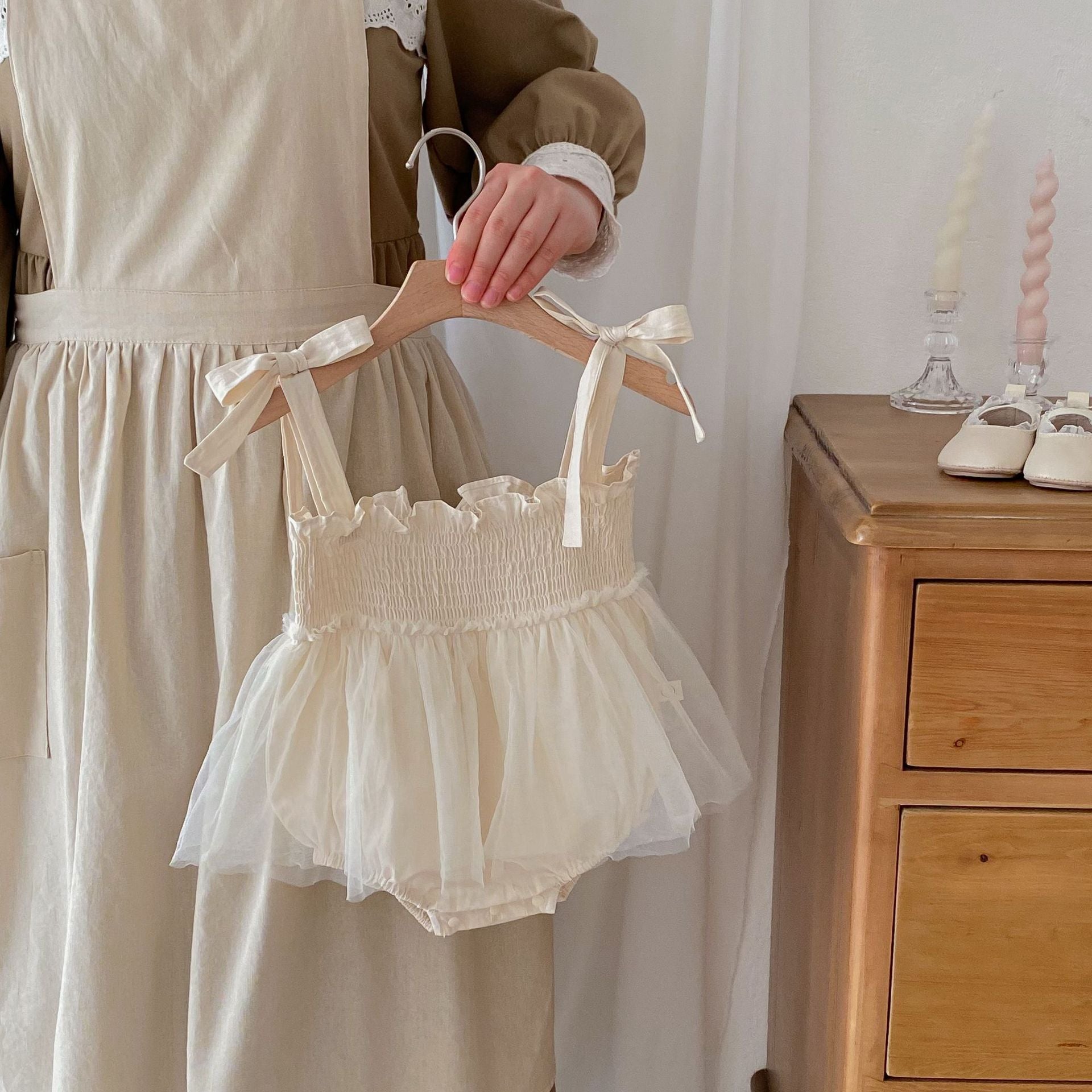 Summer New Arrival Baby Girls Sleeveless Solid Color Pleated Strap dress in pink and beige, made from cotton and polyester.