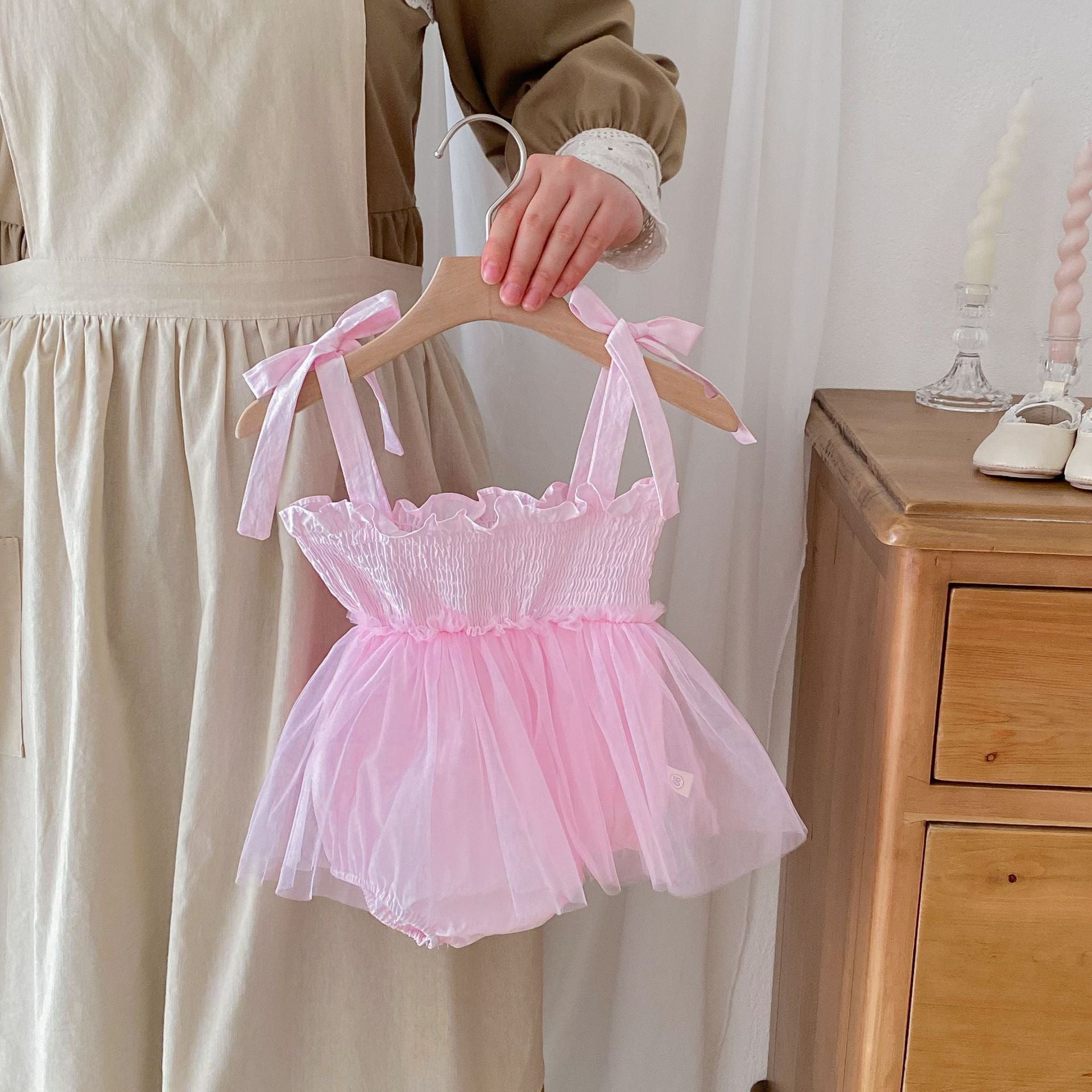 Summer New Arrival Baby Girls Sleeveless Solid Color Pleated Strap dress in pink and beige, made from cotton and polyester.