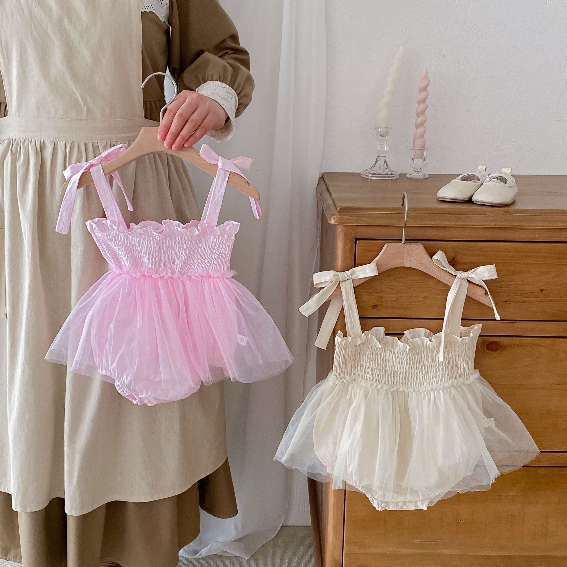 Summer New Arrival Baby Girls Sleeveless Solid Color Pleated Strap dress in pink and beige, made from cotton and polyester.