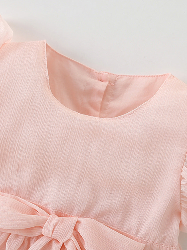 A cute pink short-sleeve top for girls featuring a bow tie detail, made from soft cotton, perfect for summer wear.