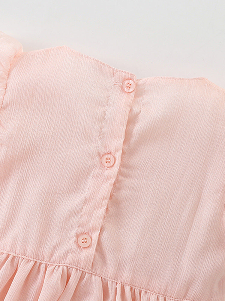 A cute pink short-sleeve top for girls featuring a bow tie detail, made from soft cotton, perfect for summer wear.