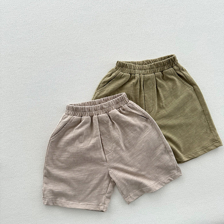 Unisex casual solid color cotton shorts in green and grey for kids, perfect for summer wear.