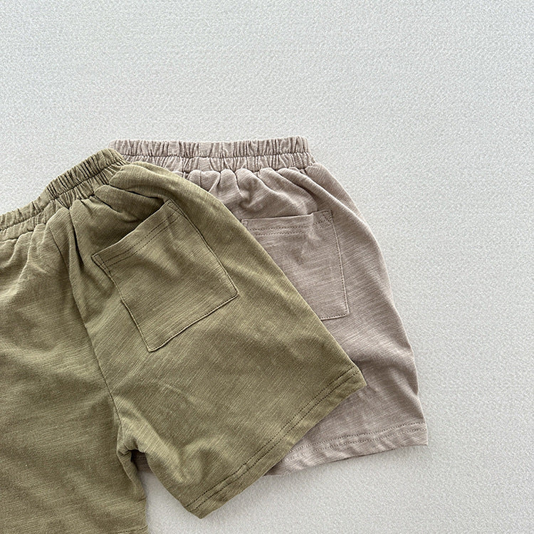 Unisex casual solid color cotton shorts in green and grey for kids, perfect for summer wear.