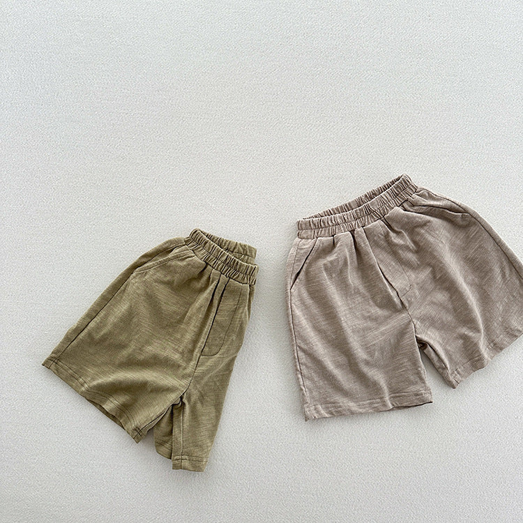 Unisex casual solid color cotton shorts in green and grey for kids, perfect for summer wear.