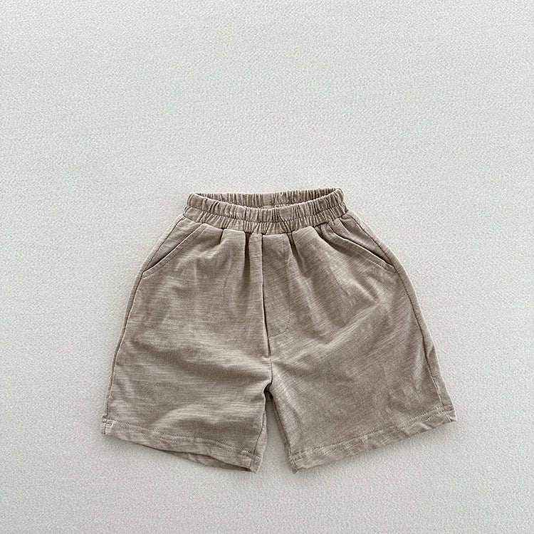 Unisex casual solid color cotton shorts in green and grey for kids, perfect for summer wear.