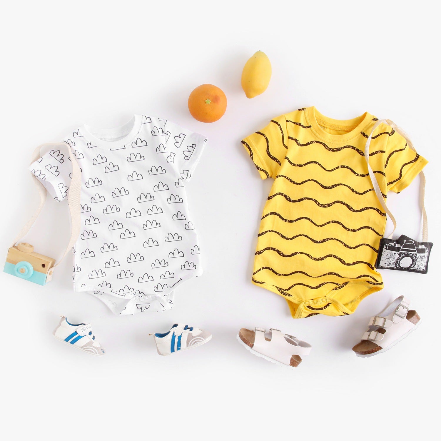 A stylish baby unisex short sleeve crew neck shirt featuring a geometric print in white and yellow colors, perfect for summer wear.