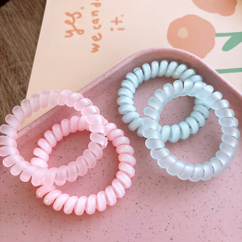 Sweet and Refreshing Matte Telephone Cord Style Hair Tie in pink and blue, designed for baby girls and girls, made from durable resin material.