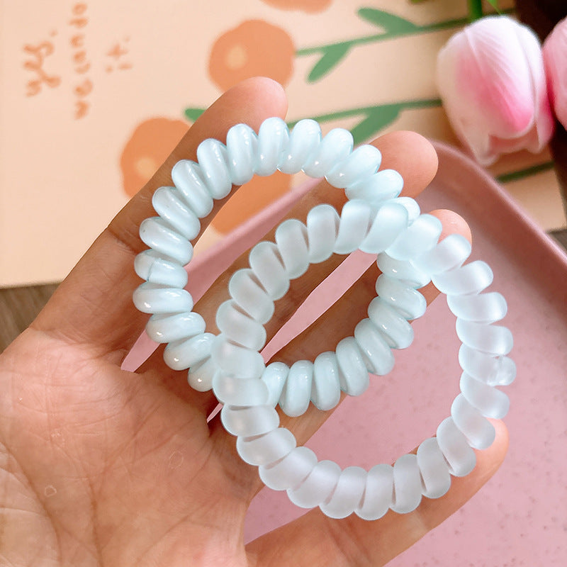 Sweet and Refreshing Matte Telephone Cord Style Hair Tie in pink and blue, designed for baby girls and girls, made from durable resin material.