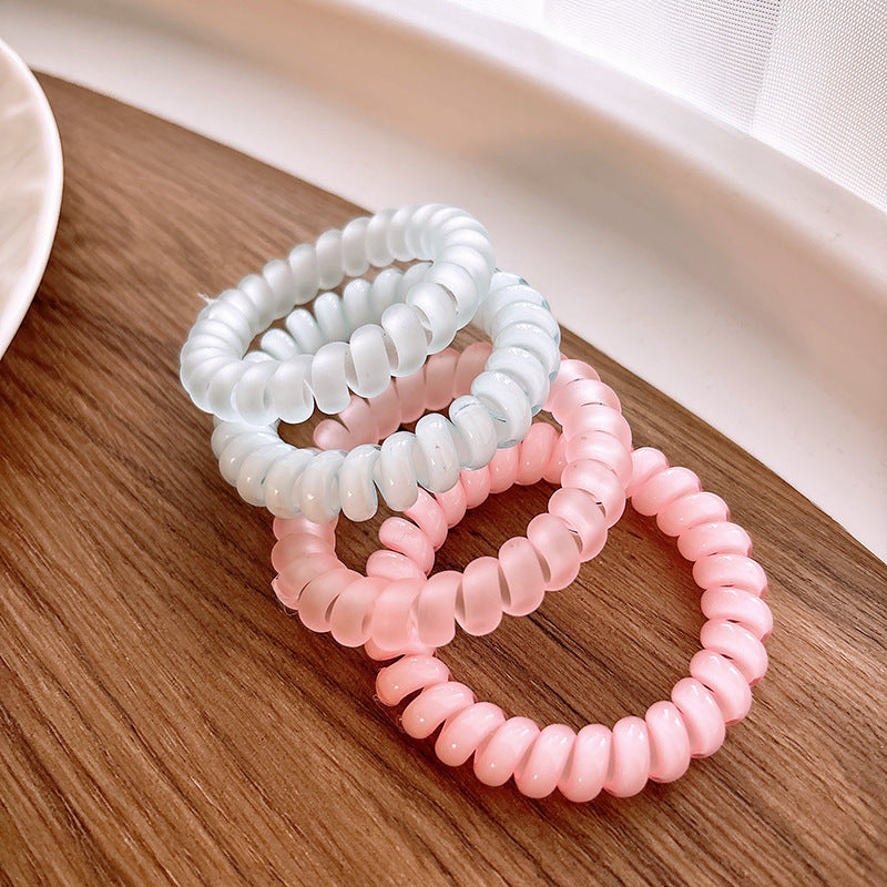 Sweet and Refreshing Matte Telephone Cord Style Hair Tie in pink and blue, designed for baby girls and girls, made from durable resin material.