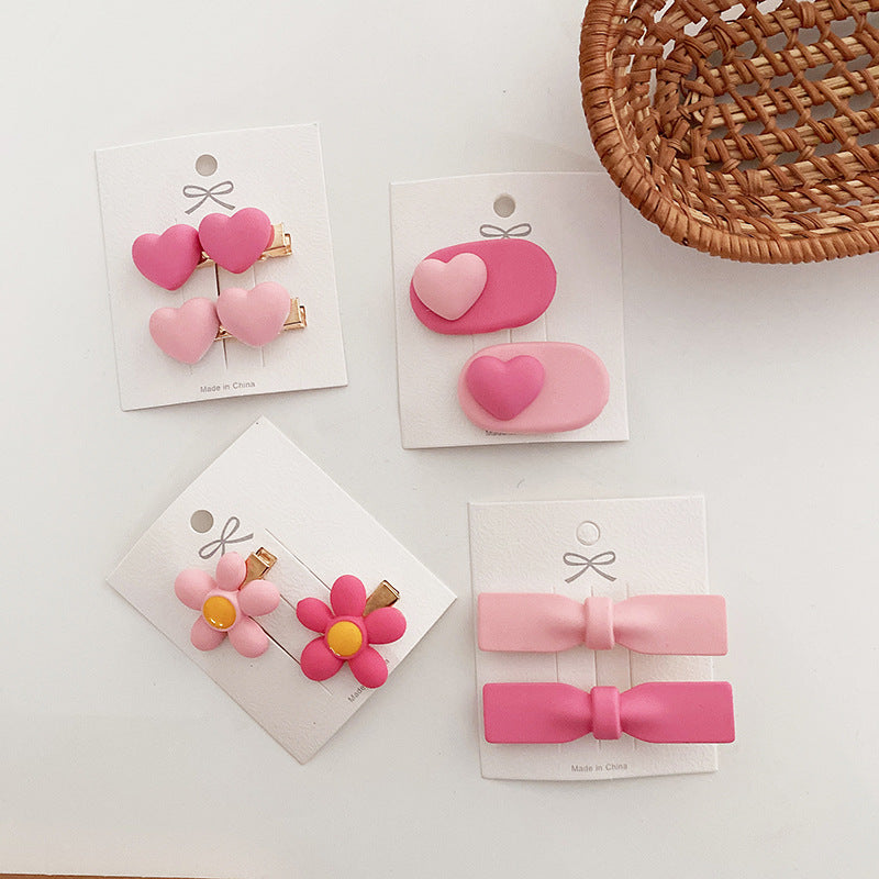 Sweet Pink Collection heart clip featuring an adorable bow, available in multiple colors for baby girls and girls.