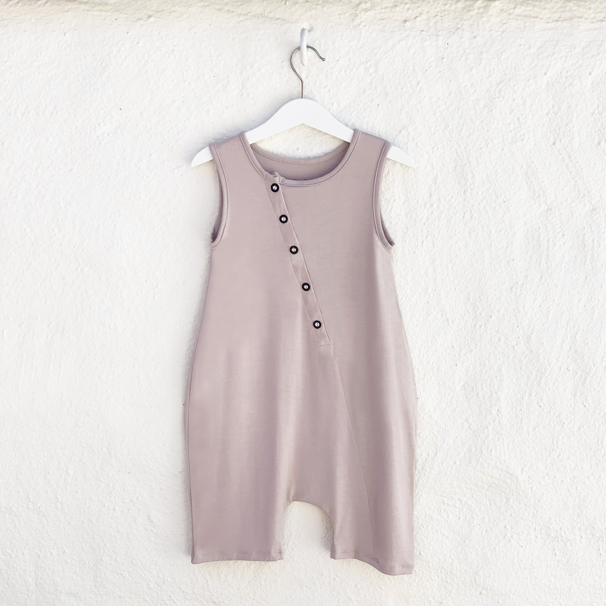 Mocha Tank Romper featuring front buttons and drop crotch design, made from soft rayon and spandex fabric.