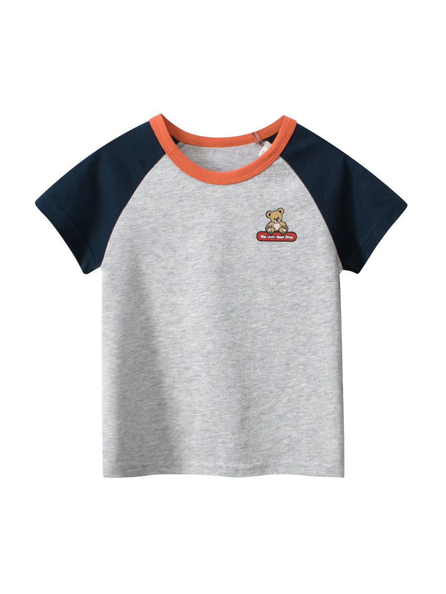 A grey girls' t-shirt featuring a cute teddy bear logo, made from soft cotton, perfect for summer wear.