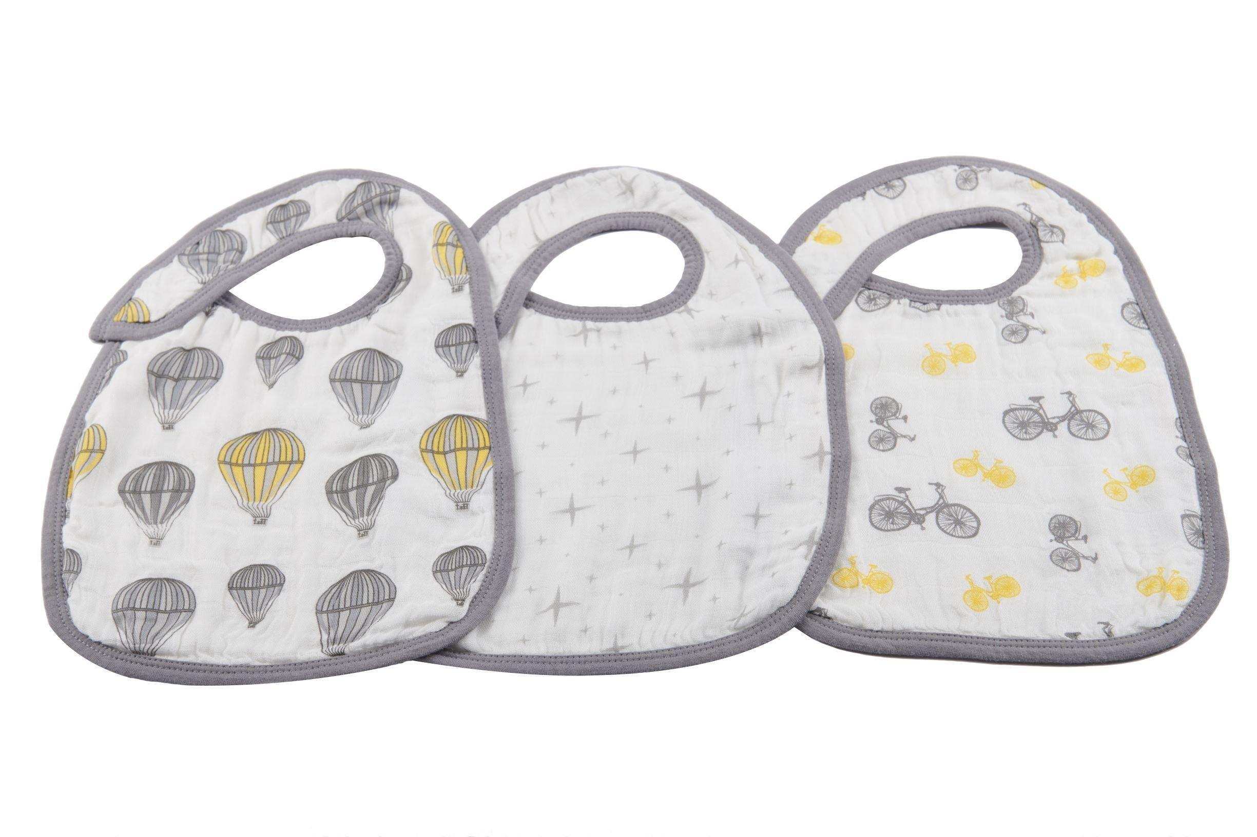 Three stylish Traveler Bamboo Muslin Snap Bibs in various colors, featuring three snaps for adjustable fit, made from soft and absorbent bamboo muslin.