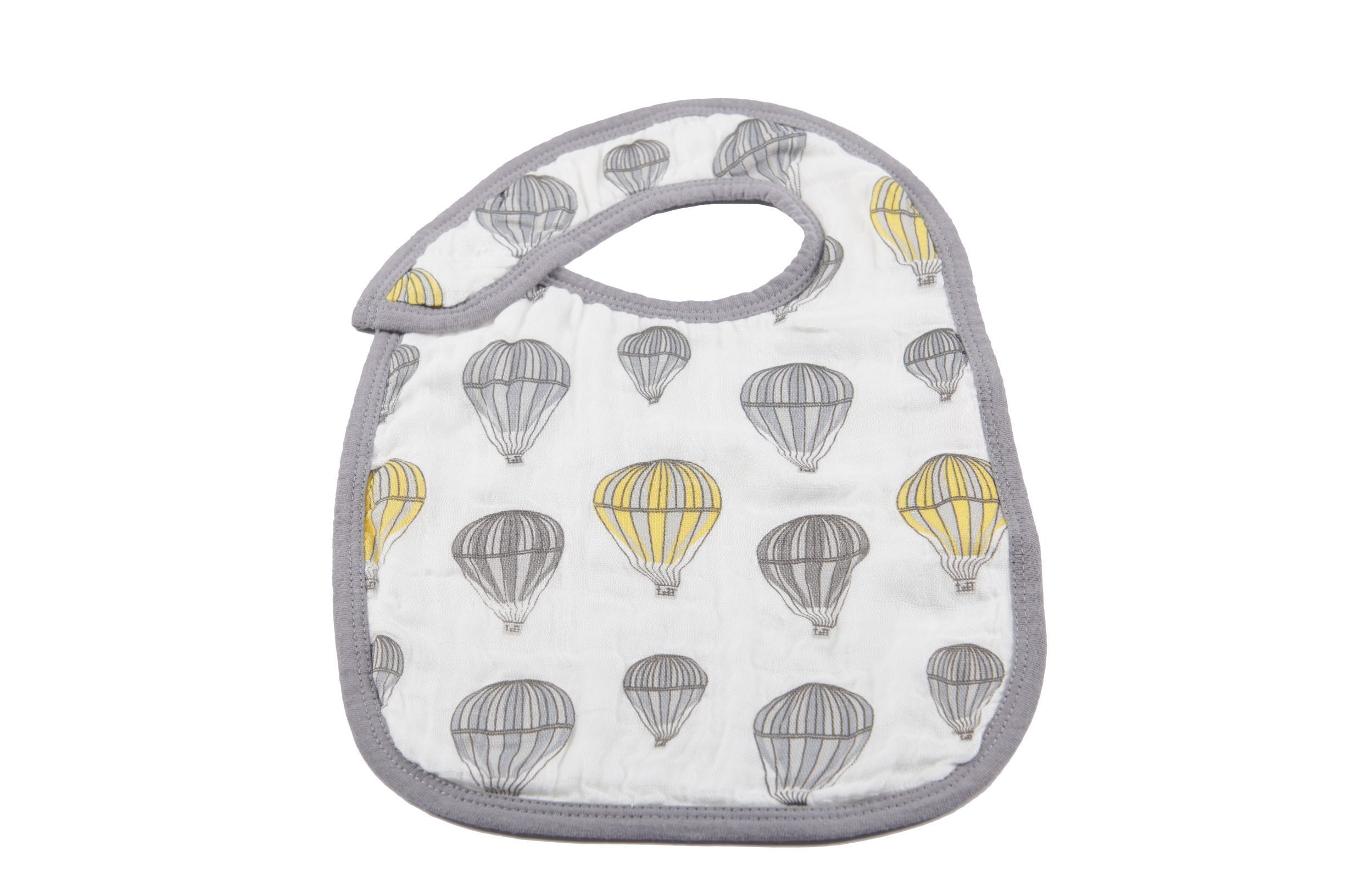 Three stylish Traveler Bamboo Muslin Snap Bibs in various colors, featuring three snaps for adjustable fit, made from soft and absorbent bamboo muslin.