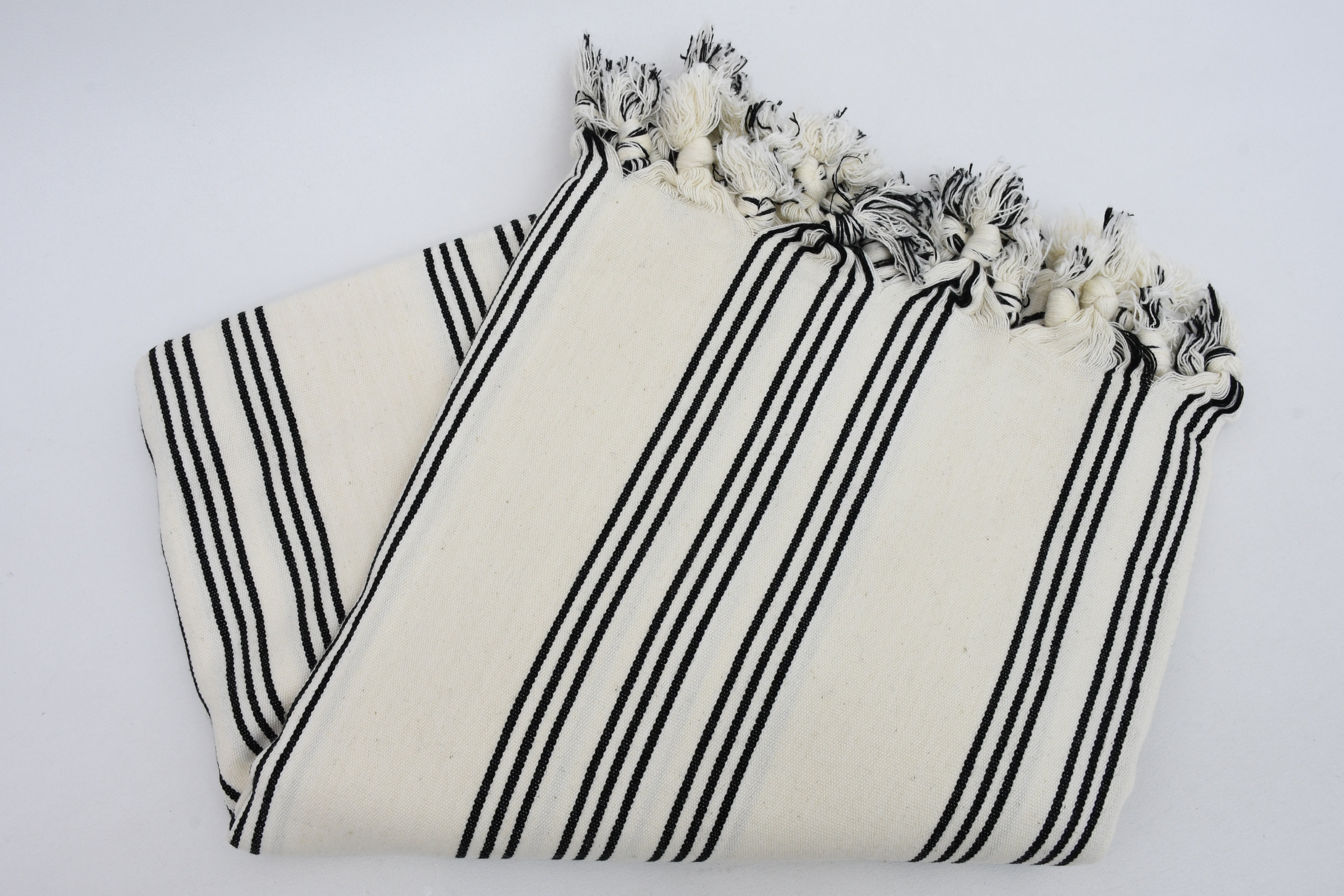 Turkish Beach Towel featuring a stylish black and white stripe design, handwoven from natural cotton, perfect for beach outings.