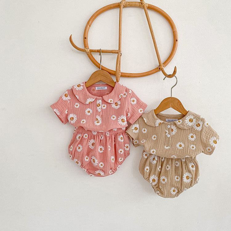 A stylish summer top for baby girls featuring short sleeves and a floral pattern in pink and khaki colors.