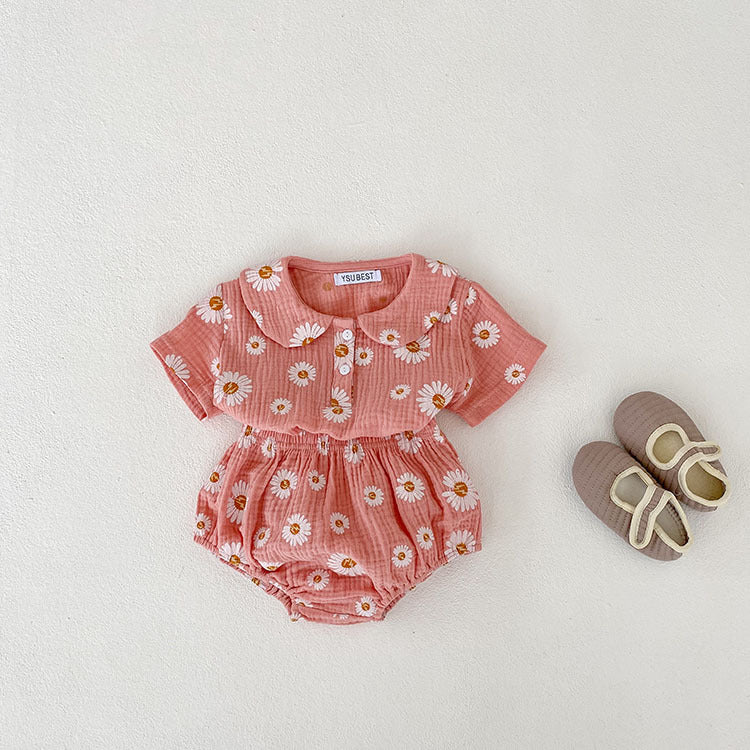 A stylish summer top for baby girls featuring short sleeves and a floral pattern in pink and khaki colors.