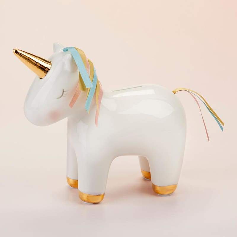 A beautifully crafted white porcelain unicorn bank with a gold foil horn and hooves, featuring a colorful mane and tail made of pink, aqua, and gold ribbons.