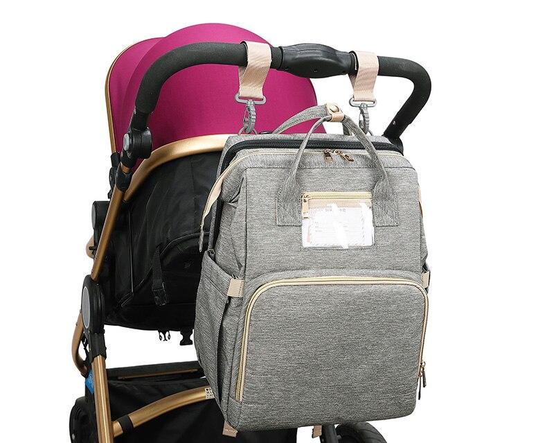 Warehouse Multifunctional Baby Folding Bed Diaper Bag in stylish design, showcasing its folding bed feature and USB charging port.