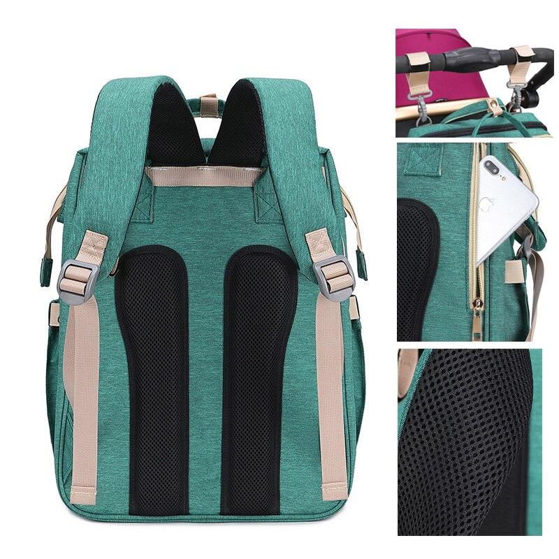 Warehouse Multifunctional Baby Folding Bed Diaper Bag in stylish design, showcasing its folding bed feature and USB charging port.