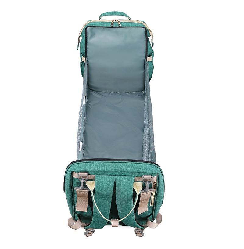 Warehouse Multifunctional Baby Folding Bed Diaper Bag in stylish design, showcasing its folding bed feature and USB charging port.