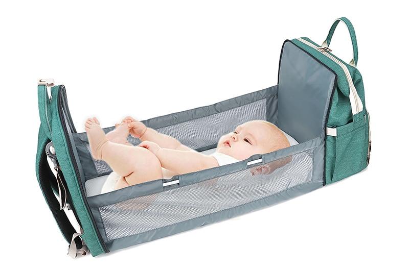 Warehouse Multifunctional Baby Folding Bed Diaper Bag in stylish design, showcasing its folding bed feature and USB charging port.