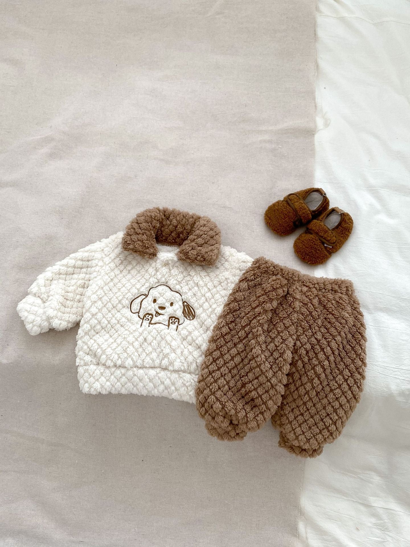 A cozy winter baby long sleeve shirt featuring a cute dog cartoon pattern in khaki and brown colors, perfect for infants and toddlers.